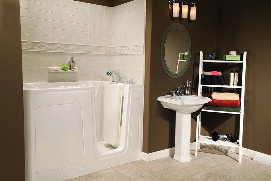 A white walk-in bathtub with a curtain, a pedestal sink, and a shelving unit in a brown-walled bathroom.