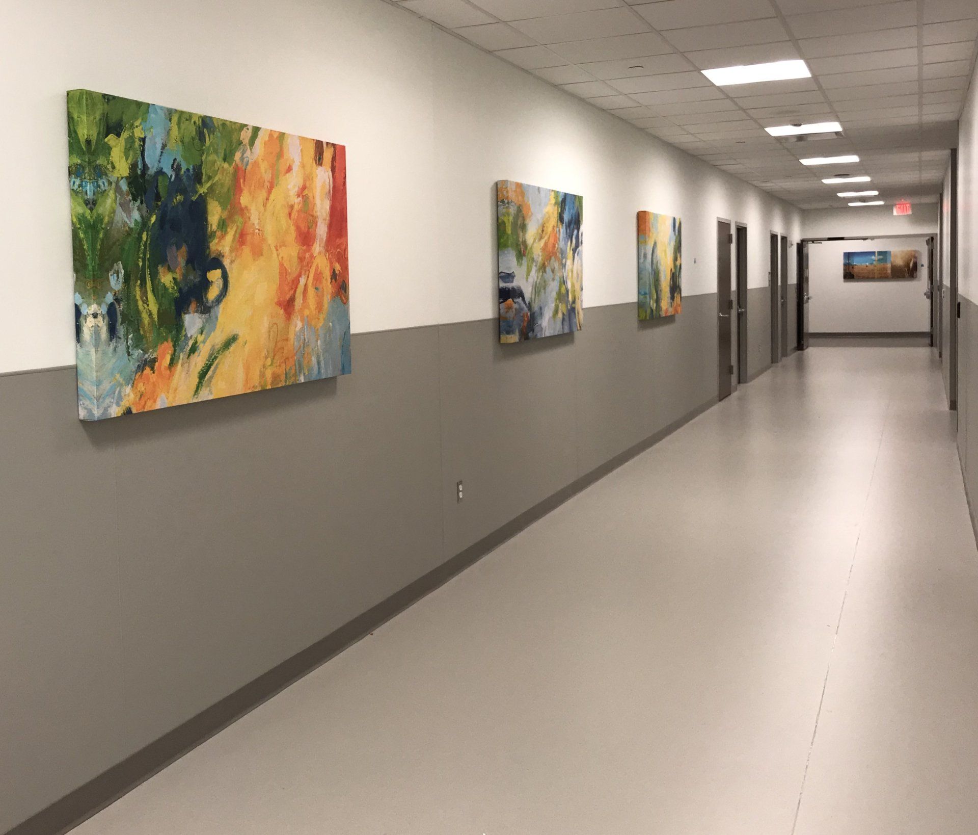 A long hallway with paintings on the wall