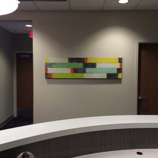 A colorful painting hangs on a wall above a reception desk