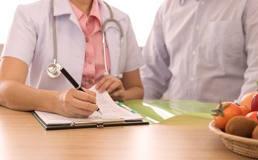 Doctor Writing on Paper — Chiropractic Clinics in Quakertown, PA