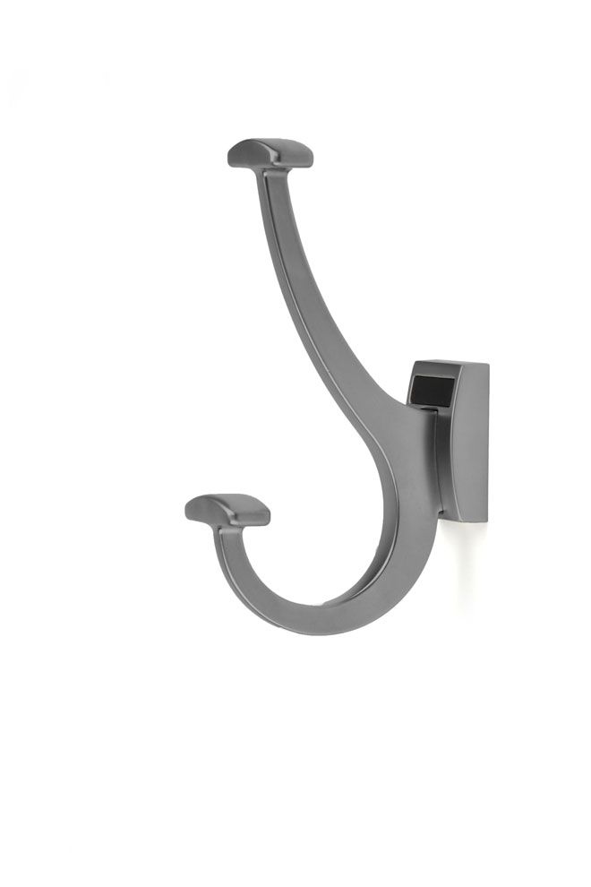 a gray hook is hanging on a white wall .