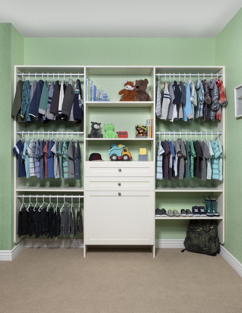 a child 's closet with lots of clothes and toys
