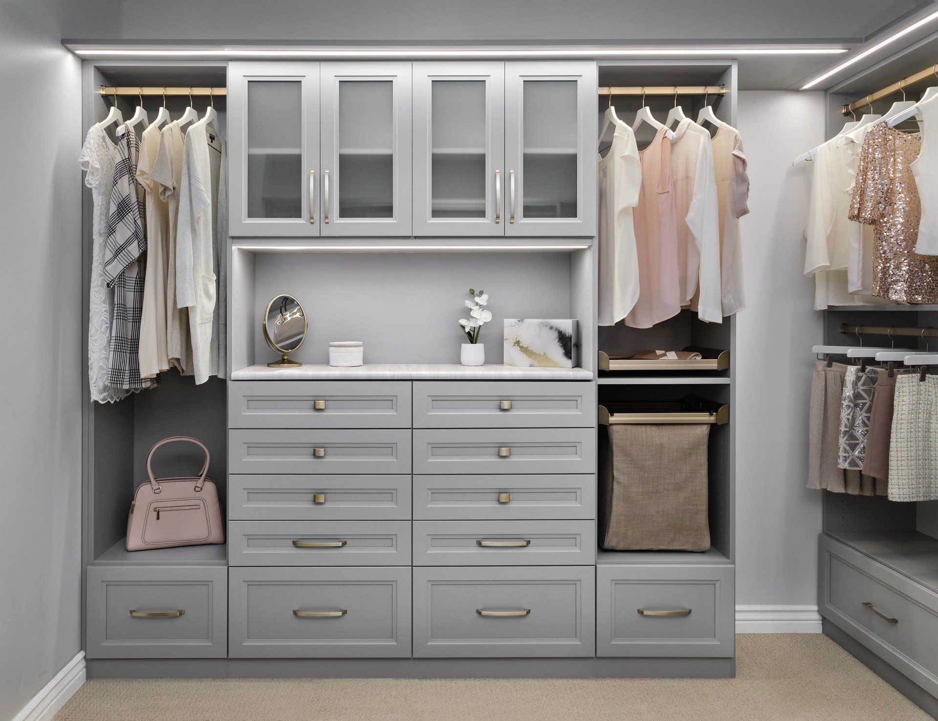 a walk in closet filled with lots of clothes and drawers .