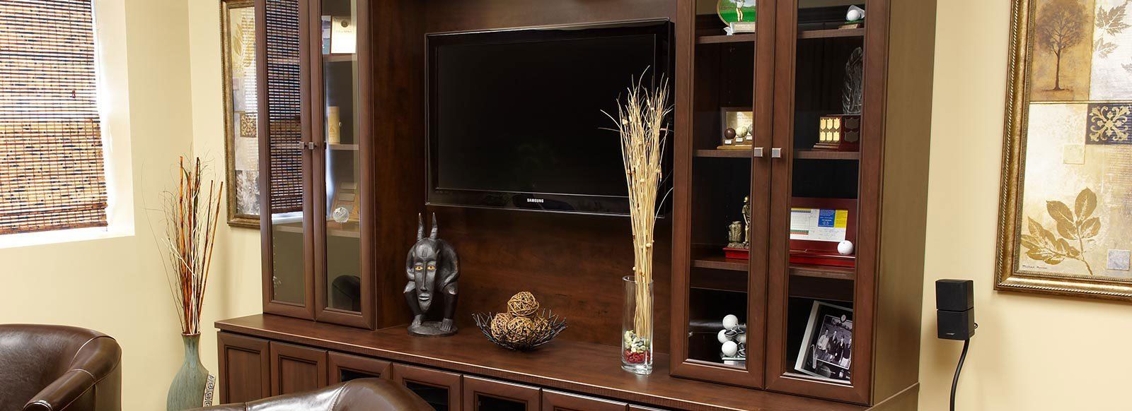 a living room with a large entertainment center and a flat screen tv .