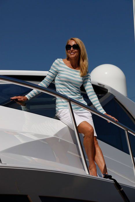 A woman is sitting on the side of a boat