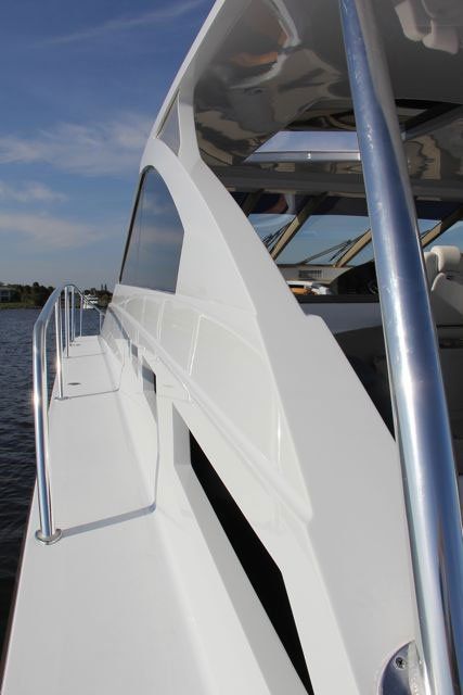 A white boat is floating on a body of water