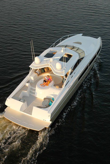 A large white boat is floating on top of a body of water.