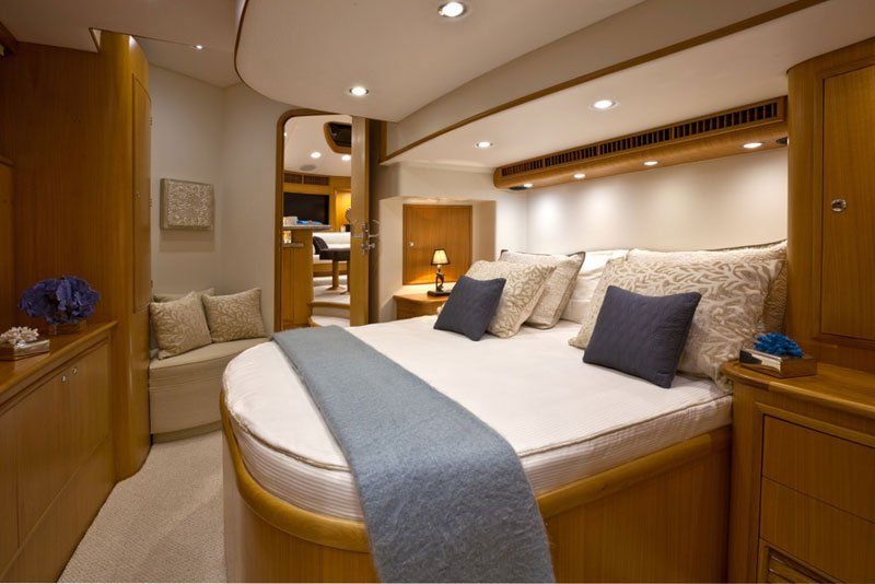 A bedroom with a round bed and blue pillows