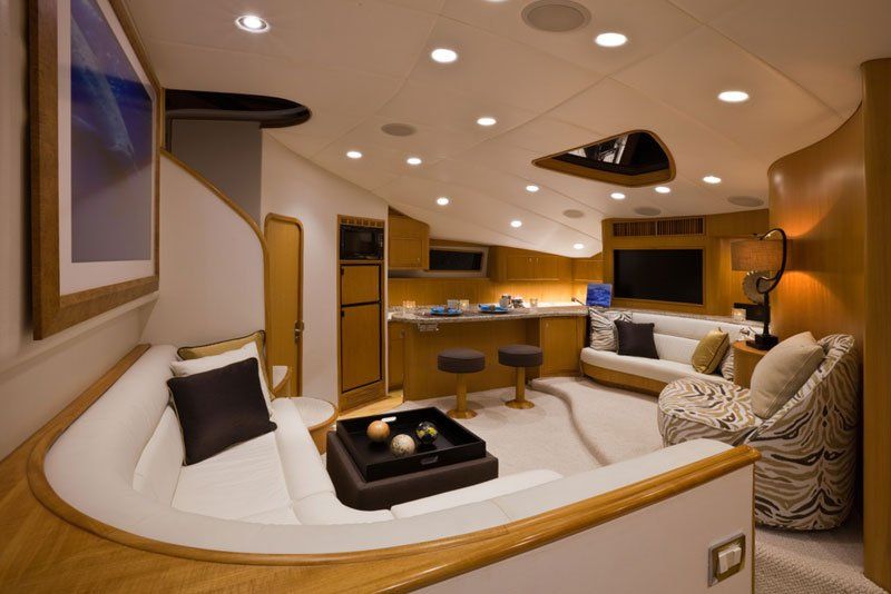 A living room on a boat with a couch and chairs