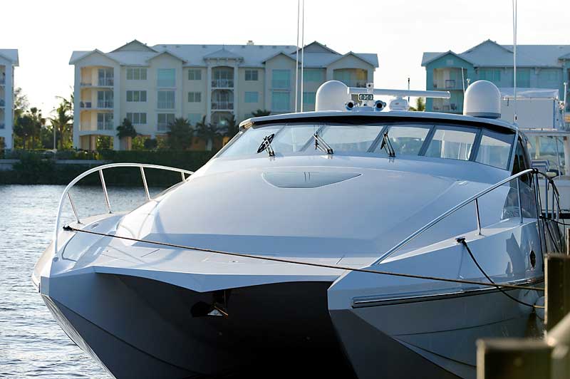 A large white boat is docked in front of a building