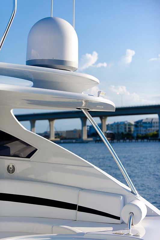 A white boat with a bridge in the background