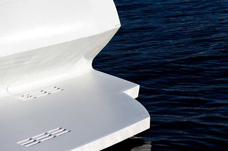A white boat is floating on top of a body of water.