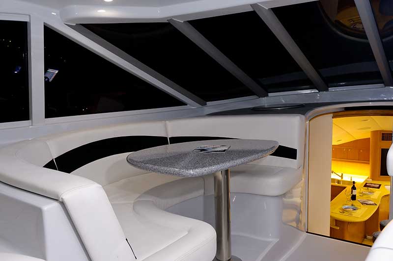 The inside of a boat with a table and a couch