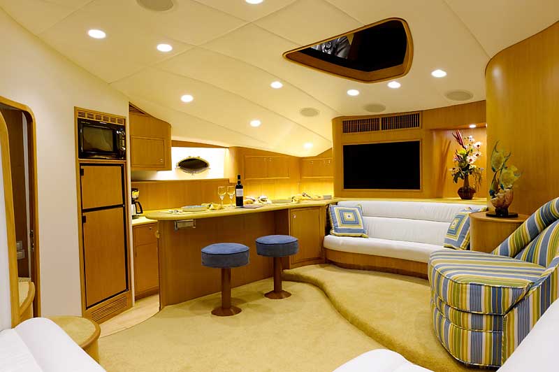 A living room on a boat with a couch and stools