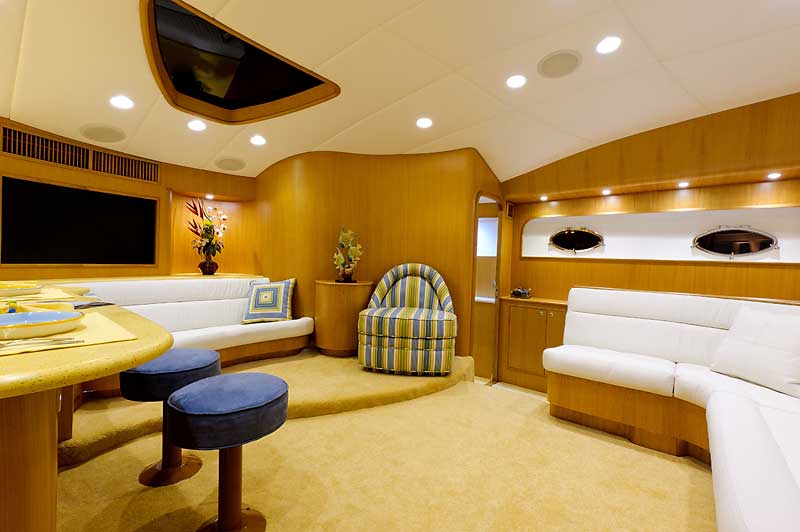 A living room with a couch , chair , table and television.