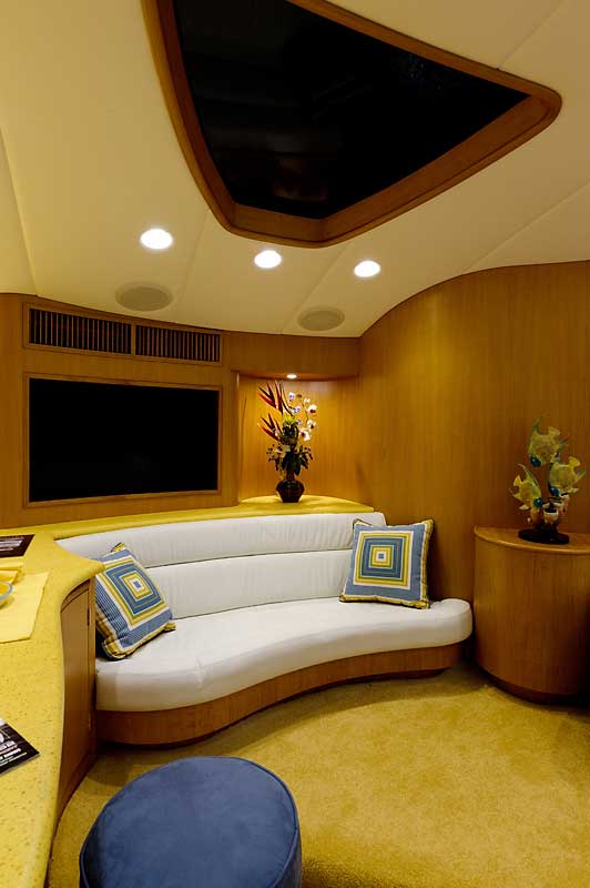 A living room with a curved couch and a flat screen tv