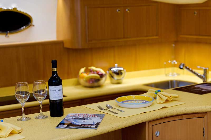 A bottle of wine sits on a counter in a kitchen.