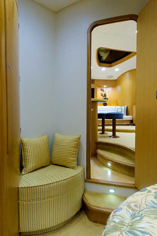 A room with a couch and stairs leading to a living room.