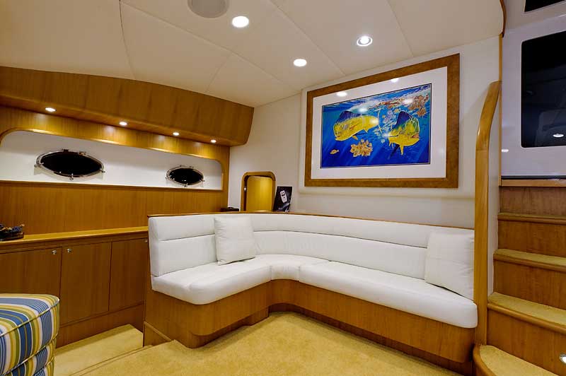 A living room with a couch and a picture on the wall