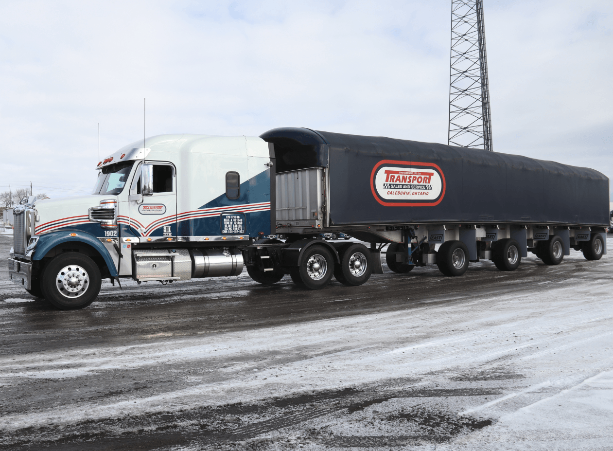 A large semi truck is parked in the snow.