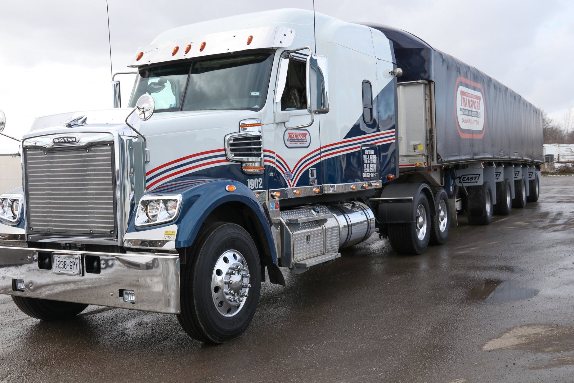 A large semi truck is parked in a parking lot