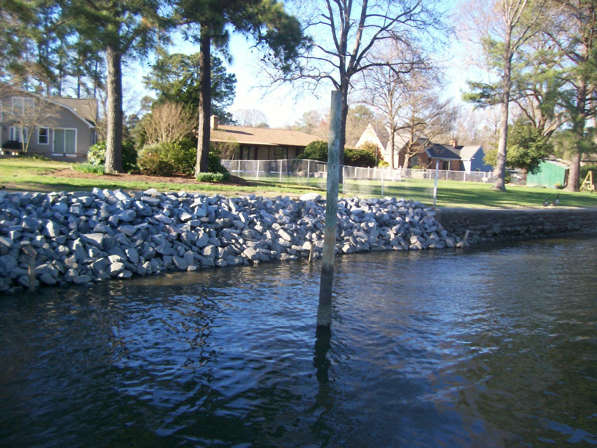 Rip Rap Repair — Lake With Rip Rap With Houses in Shacklefords, VA