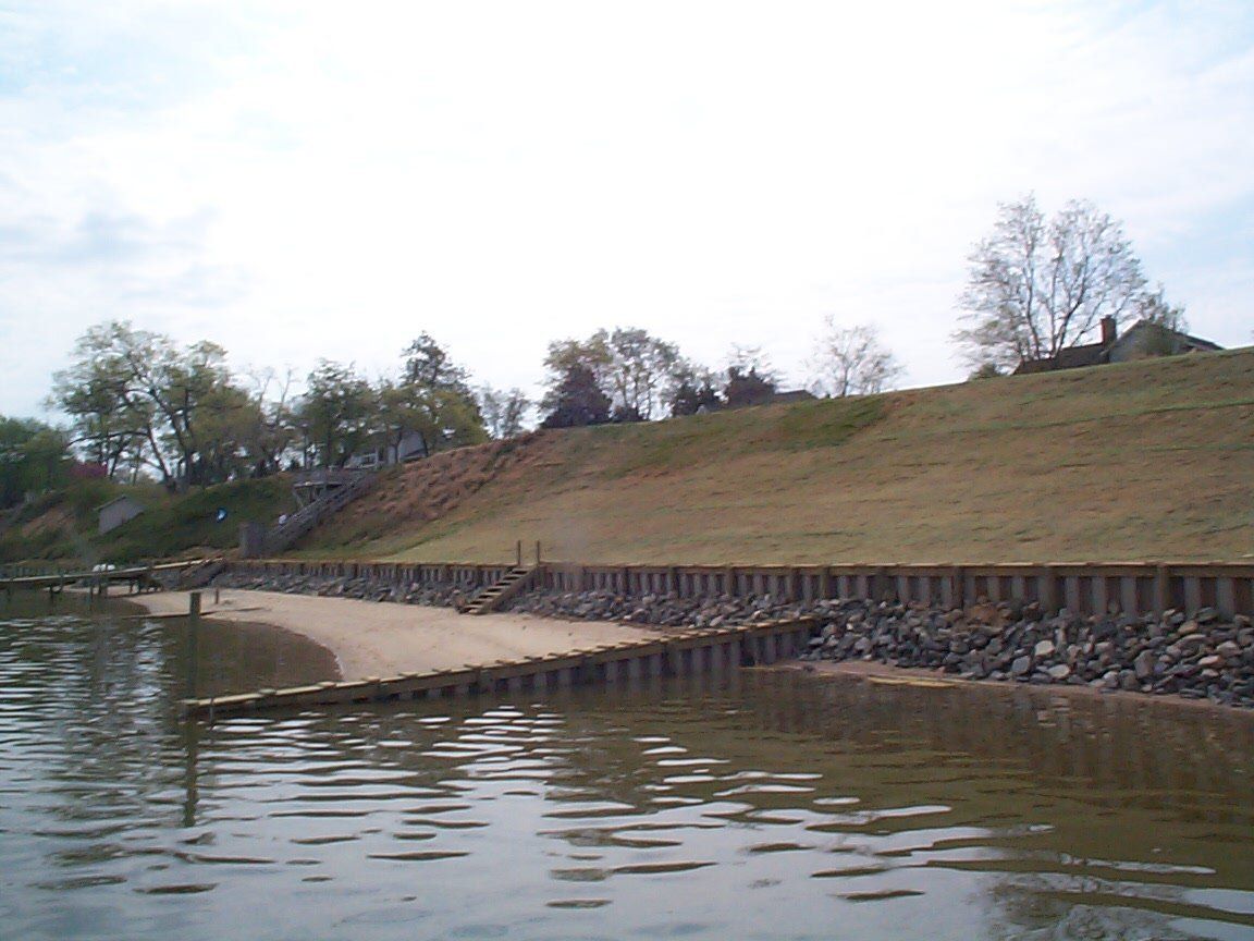 Excavation And Grading Service — Houses On Top Hill and Seawall On Bottom in Shacklefords, VA