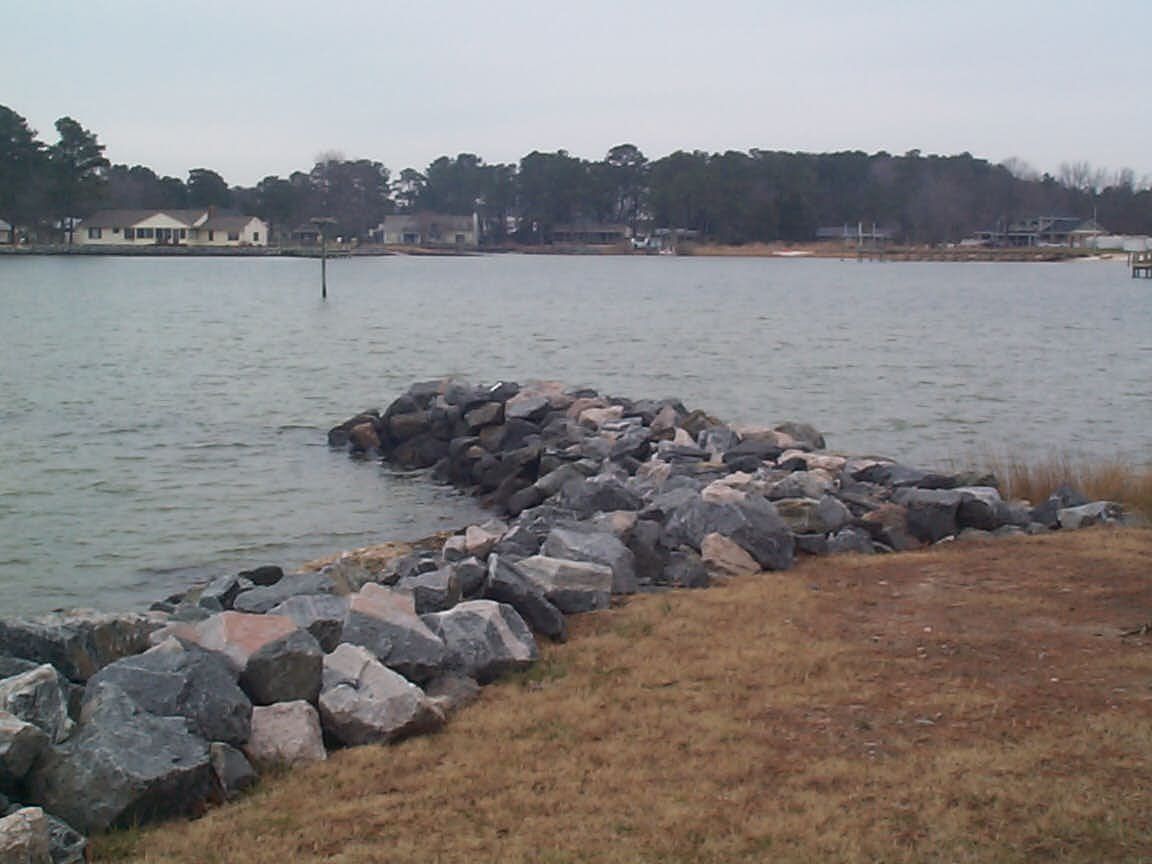 Rip Rap Installation Service — Rip Rap On Lake With Brown Grass in Shacklefords, VA