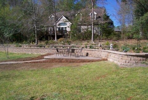 Landscape Design & Installation Service — Retaining Wall Below A Elegant House in Shacklefords, VA