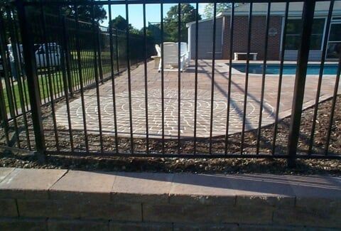 Landscape Lightning — Black Metal Fence Surrounds A Patio in Shacklefords, VA