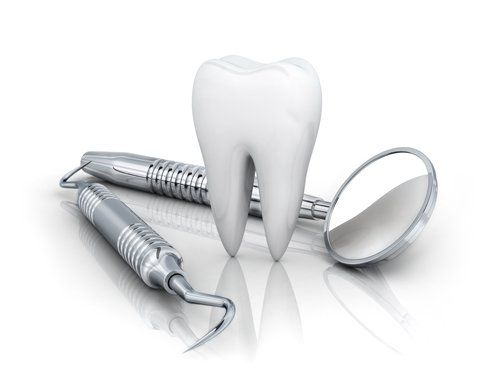 modellino di dente con specchietto e strumenti del dentista