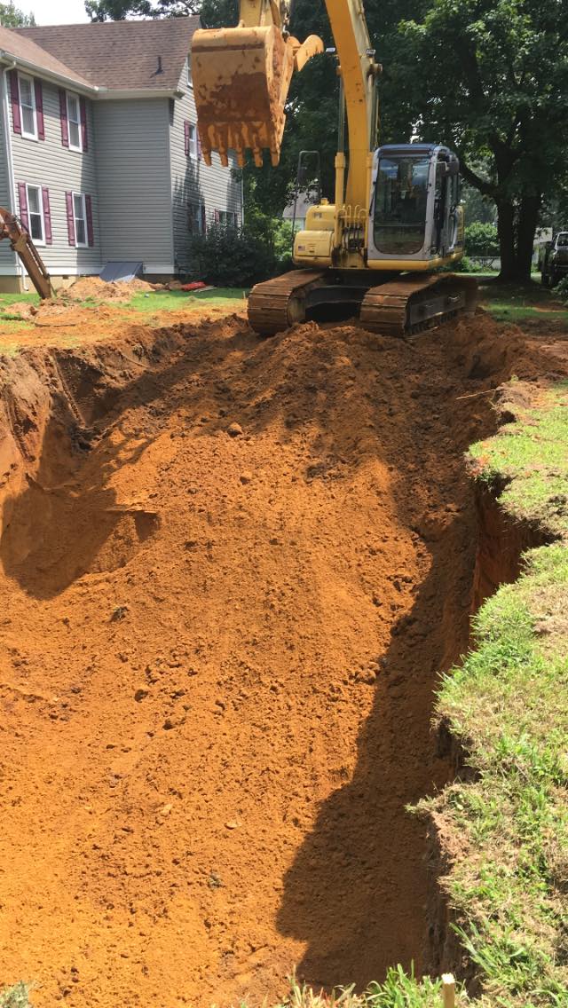 Yellow Excavator Digging Up the Soil — Newfield, NJ — Del Monte Waste Removal