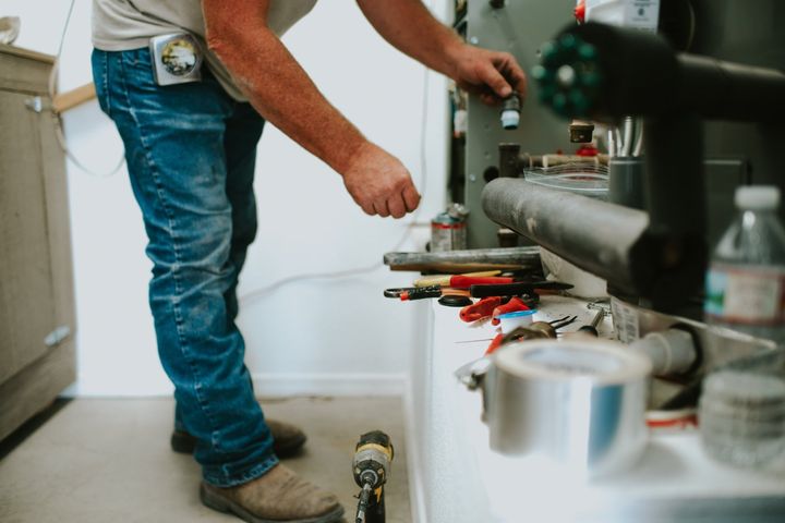 Heating & Air Conditioning Products — Employee Looking Up in Roswell, NM