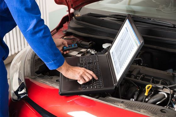 Mechanic examining car engine in La Crosse Mechanic examining car engine in La Crosse