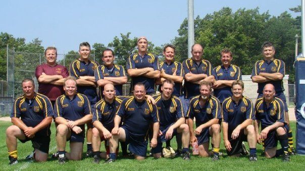 A group of men posing for a picture with their arms crossed