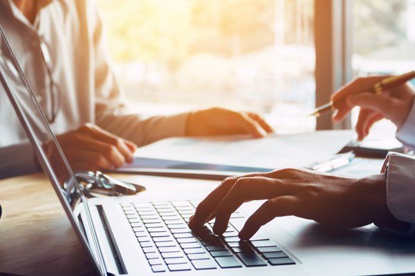Insurance Agent Typing On Laptop — Holyoke, MA — Bresnahan Insurance Agency