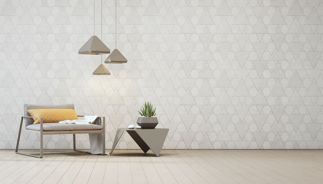 ambiente con arredi geometrici e carta da parati abbinata