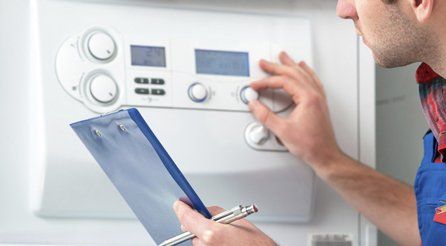 A gas safe technician checking a boiler