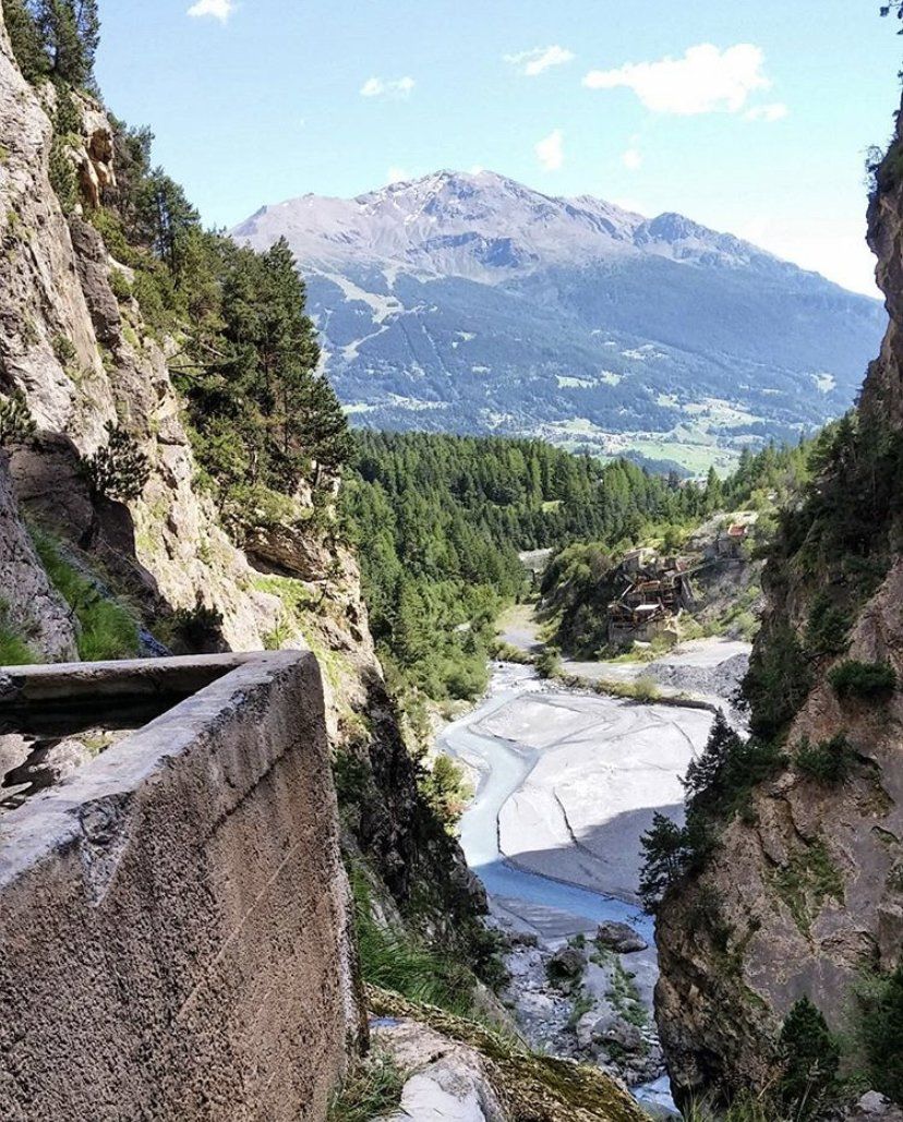 Un fiume che scorre attraverso un canyon con le montagne sullo sfondo.
