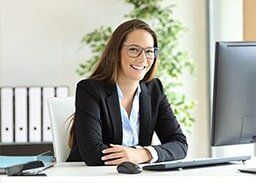 Smiling woman at work — Business Insurance in Merrillville, IN Smiling woman at work — Business Insurance in Merrillville, IN