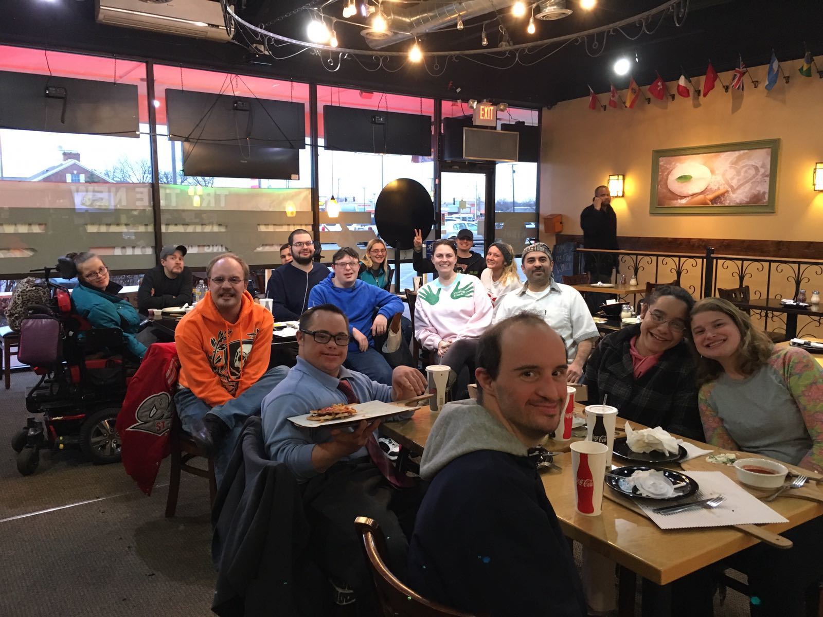 A group of people are sitting at tables in a restaurant