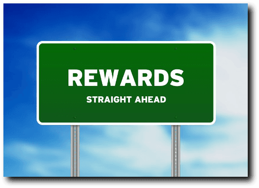 A green sign that says rewards straight ahead