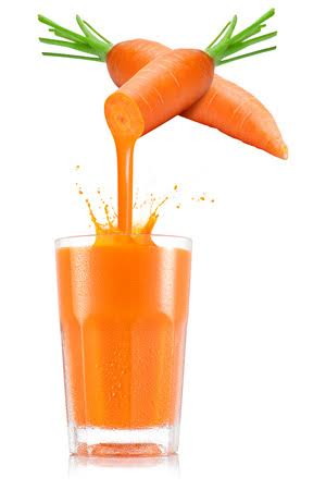 Carrots are being poured into a glass of carrot juice.
