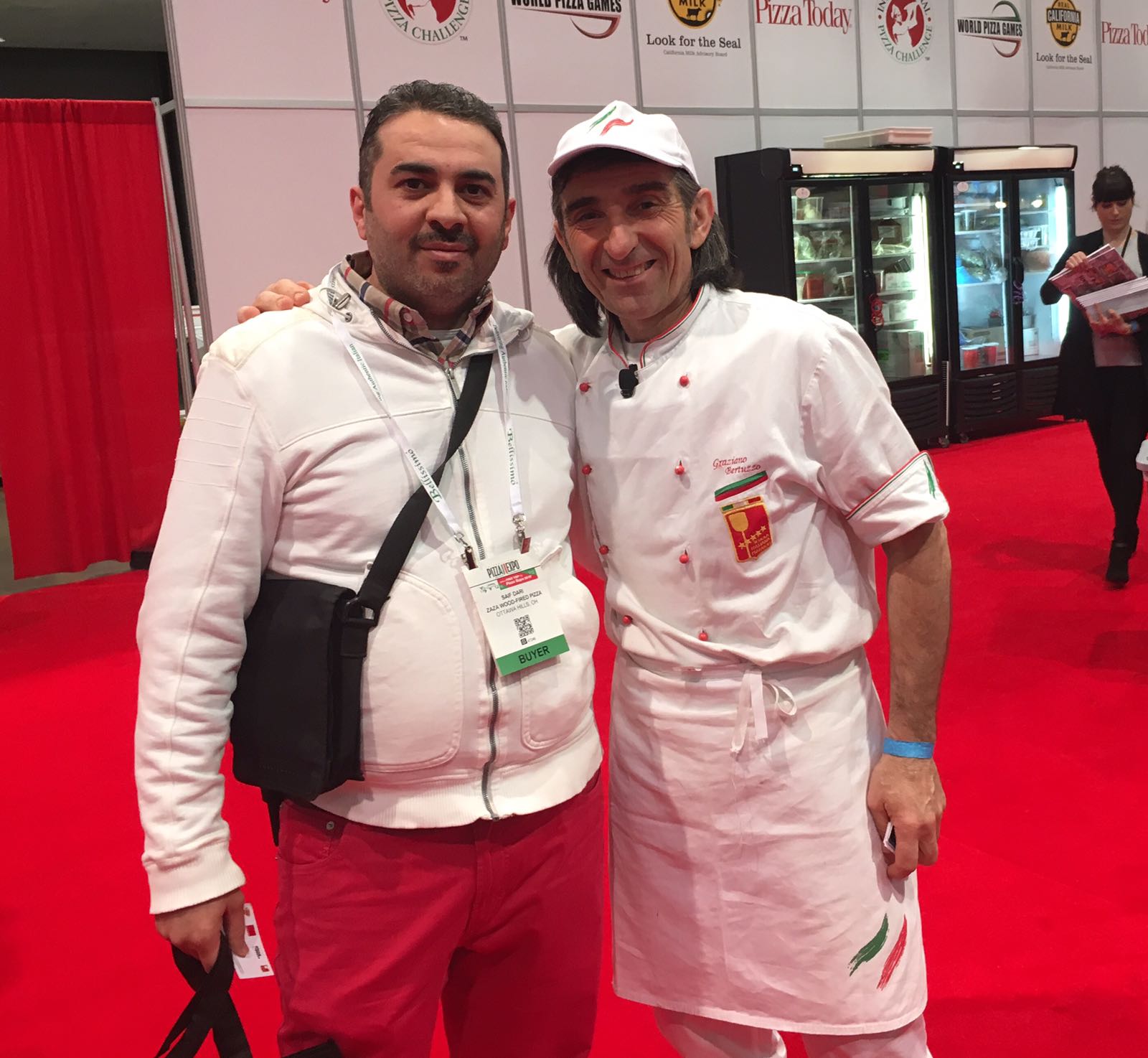 Two men are posing for a picture and one has a name tag that says ' a ' on it