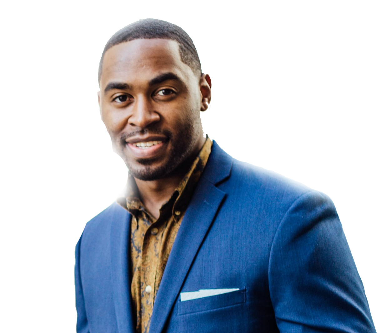 Man in a blue blazer and patterned shirt smiling against a white background