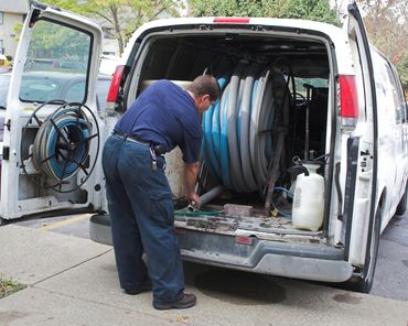 Man at the Back of Van with Carpet Cleaning Supplies