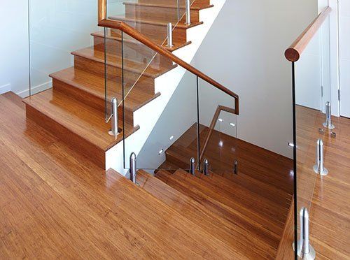 modern wooden staircase with glass and wood railings