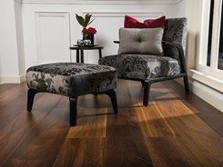 Armchair with ottoman on wood floor