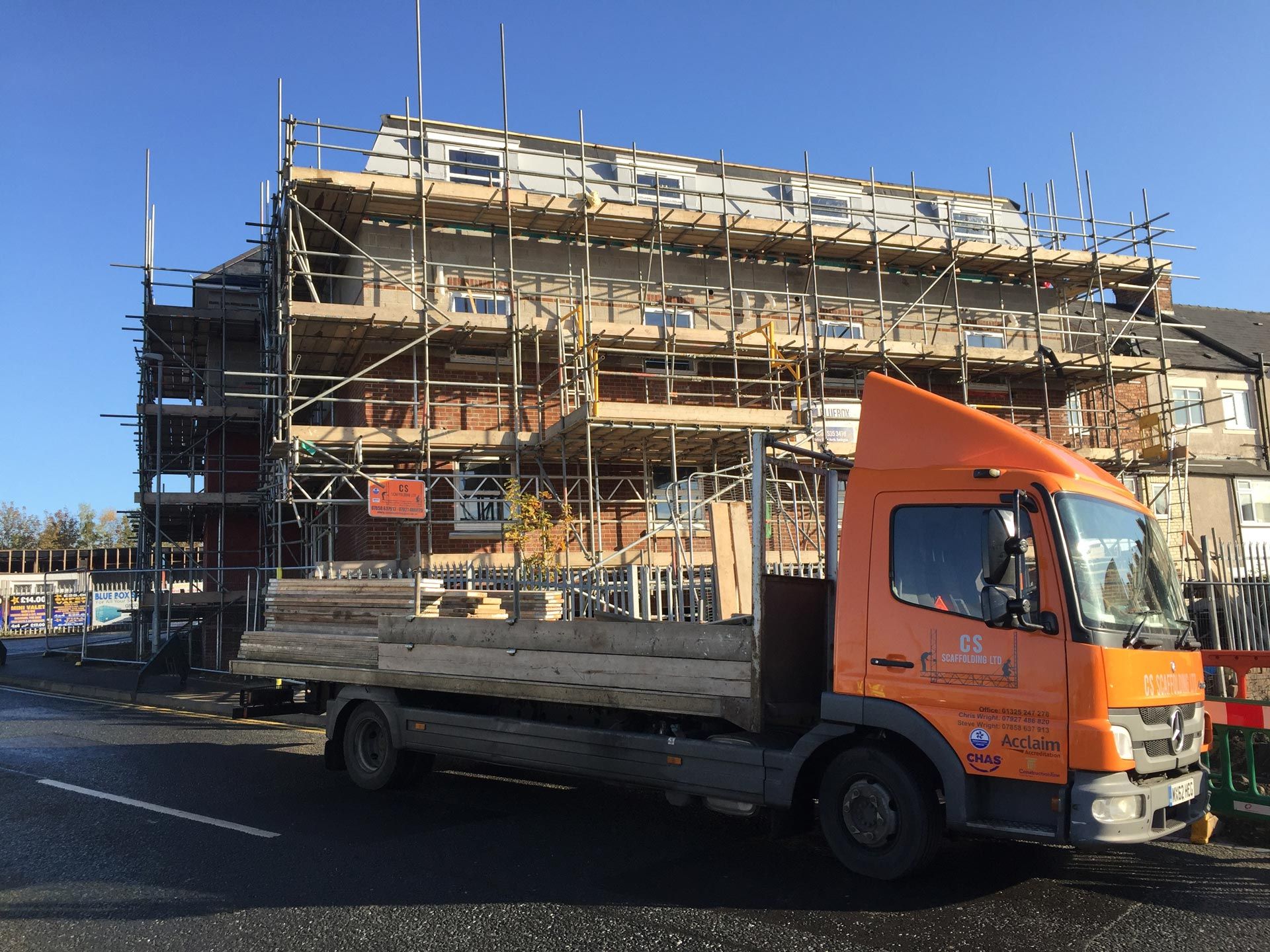 Small block of new build apartments and CS scaffolding truck