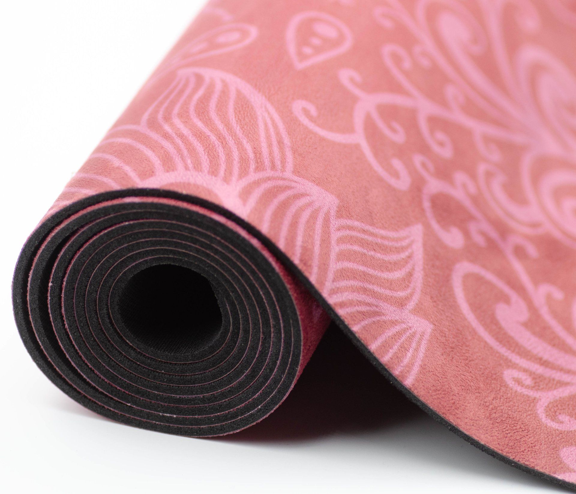 En rosa yogamatte med hjerter og blader på